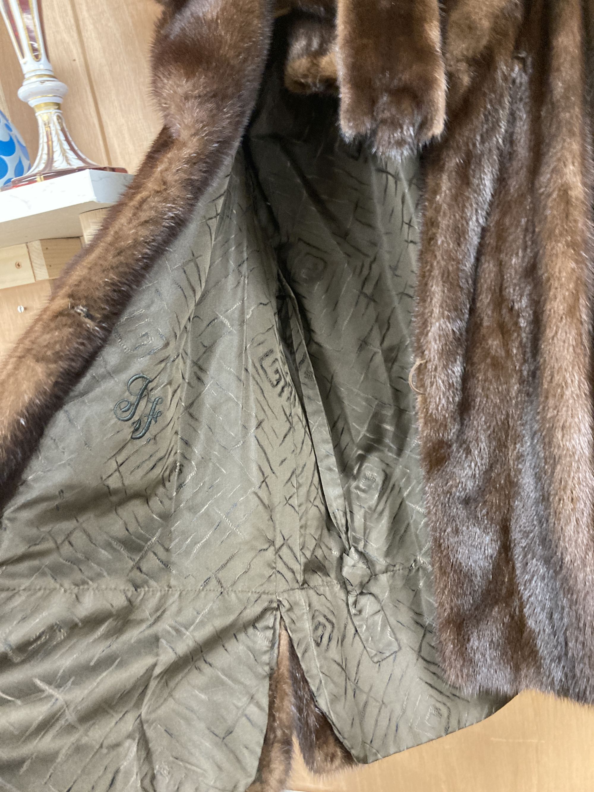 A brown mink fur coat, hat and ties